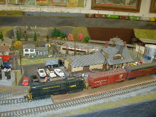 The local passenger train makes a station stop.